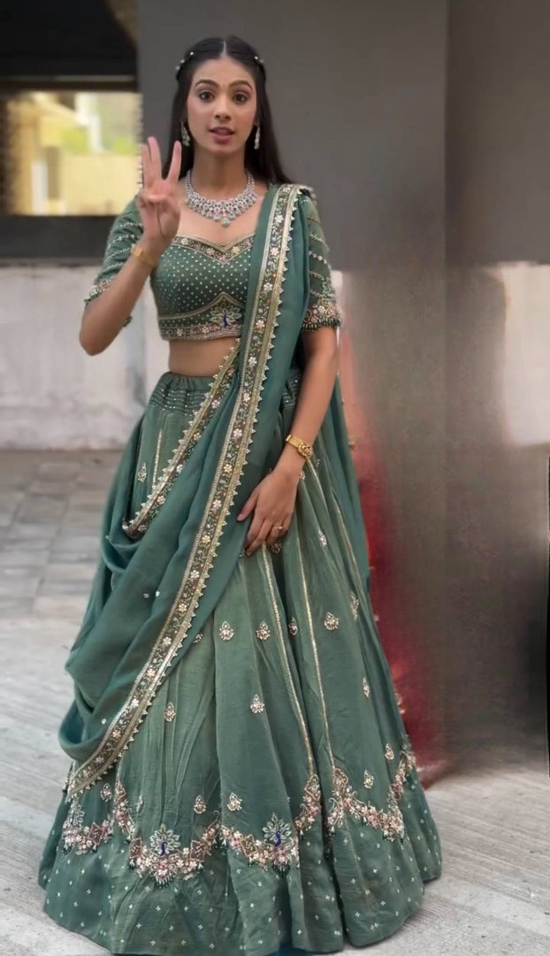 Harshita Emerald Green & Rust Maroon in Intricate Zari Embroidery with Stone Lehenga Choli