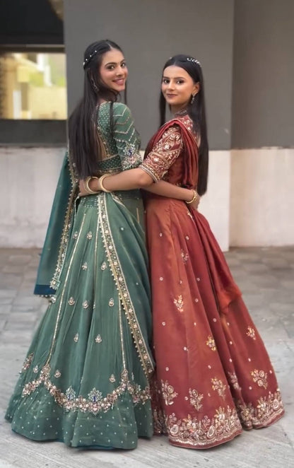 Harshita Emerald Green & Rust Maroon in Intricate Zari Embroidery with Stone Lehenga Choli
