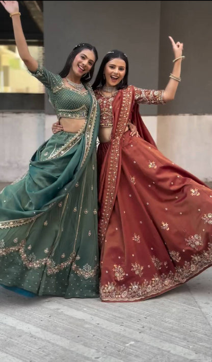 Harshita Emerald Green & Rust Maroon in Intricate Zari Embroidery with Stone Lehenga Choli