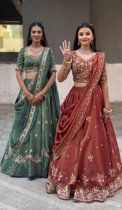 Harshita Emerald Green & Rust Maroon in Intricate Zari Embroidery with Stone Lehenga Choli