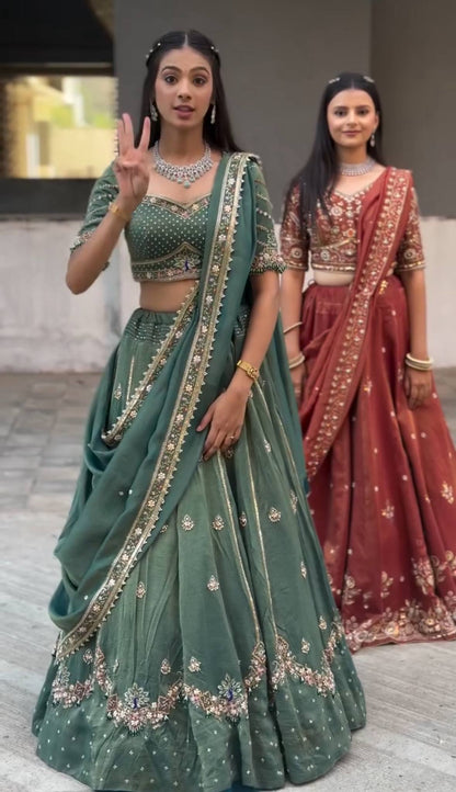 Harshita Emerald Green & Rust Maroon in Intricate Zari Embroidery with Stone Lehenga Choli